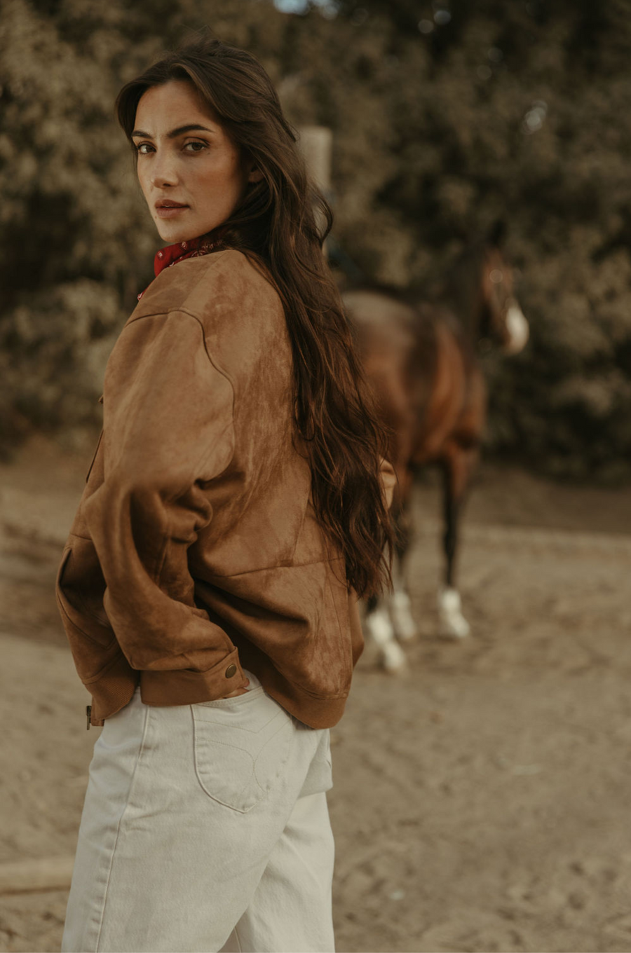 Tan brown faux suede jacket. Front zipper closure. Front and side pockets. Long sleeves with button closures. Fully lined. suede bomber jacket