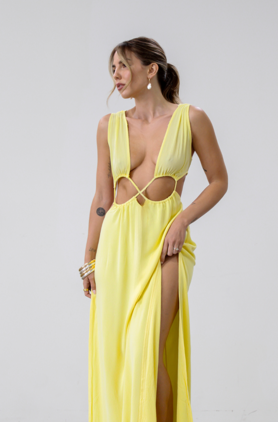 Crinkle woven sleeveless maxi dress. Waist cut outs. Side slits. Back tie closure. Back drawstring waist closure. Partially lined. vacation dress. beach dress. yellow maxi dress. 