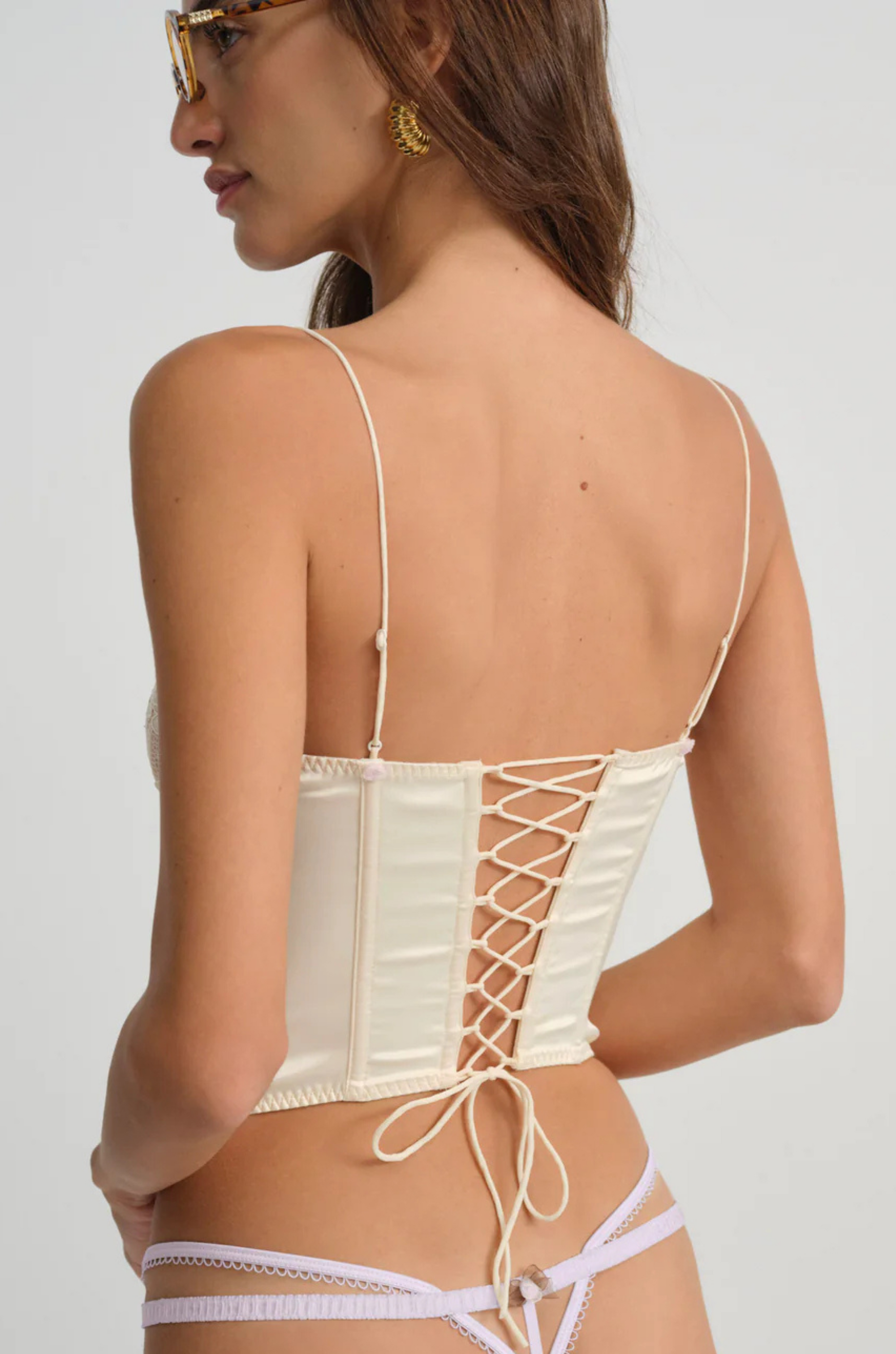 cream Sleek satin bustier with lace detailing
Fully boned bodice
Adjustable lace-up back
Skinny tie bow
Rosette adornments
Lined at cups
Adjustable shoulder straps
Polyester/Elastane
cream ligneire bustier top