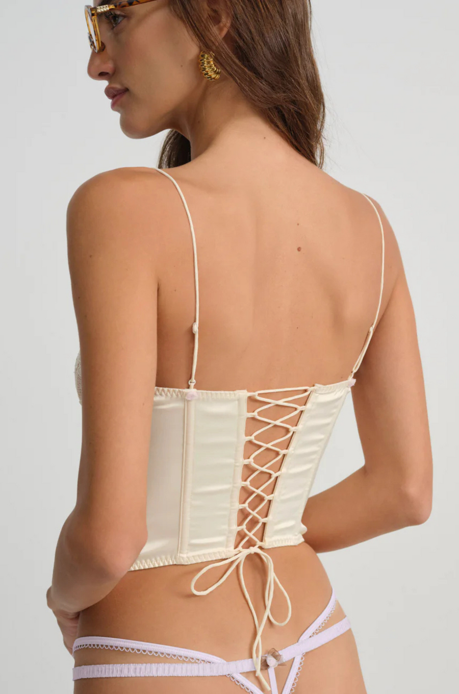 cream Sleek satin bustier with lace detailing
Fully boned bodice
Adjustable lace-up back
Skinny tie bow
Rosette adornments
Lined at cups
Adjustable shoulder straps
Polyester/Elastane
cream ligneire bustier top
