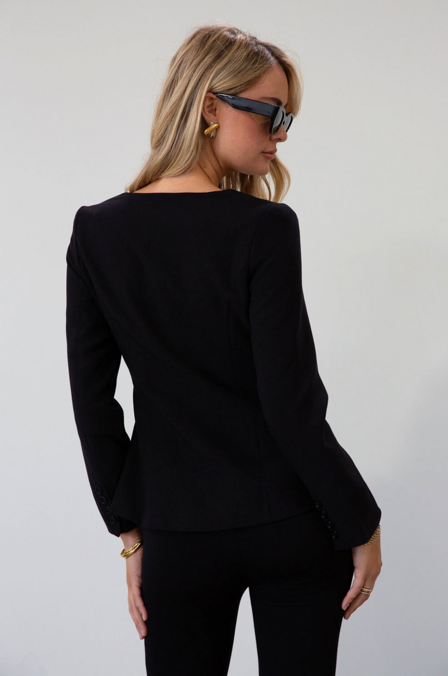 black Woven blazer style top. Long sleeves with faux button closures. Square neckline. Front button down closure. Faux front pockets. Fully lined. black fall top. work top