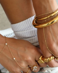 Two bezel-set cubic zirconia stones hand chain
This ultra-sleek, tarnish-free hand chain is crafted from premium stainless steel and designed to keep its shine through every hand wash and pump of sanitizer.
Just the right amount of sparkle, catching the light with your every move.
Lightweight yet bold, it layers effortlessly or stuns solo with a clean, minimalist edge.
Wear it. Wash your hands. Repeat. This is your new everyday flex.
Gold hand chain