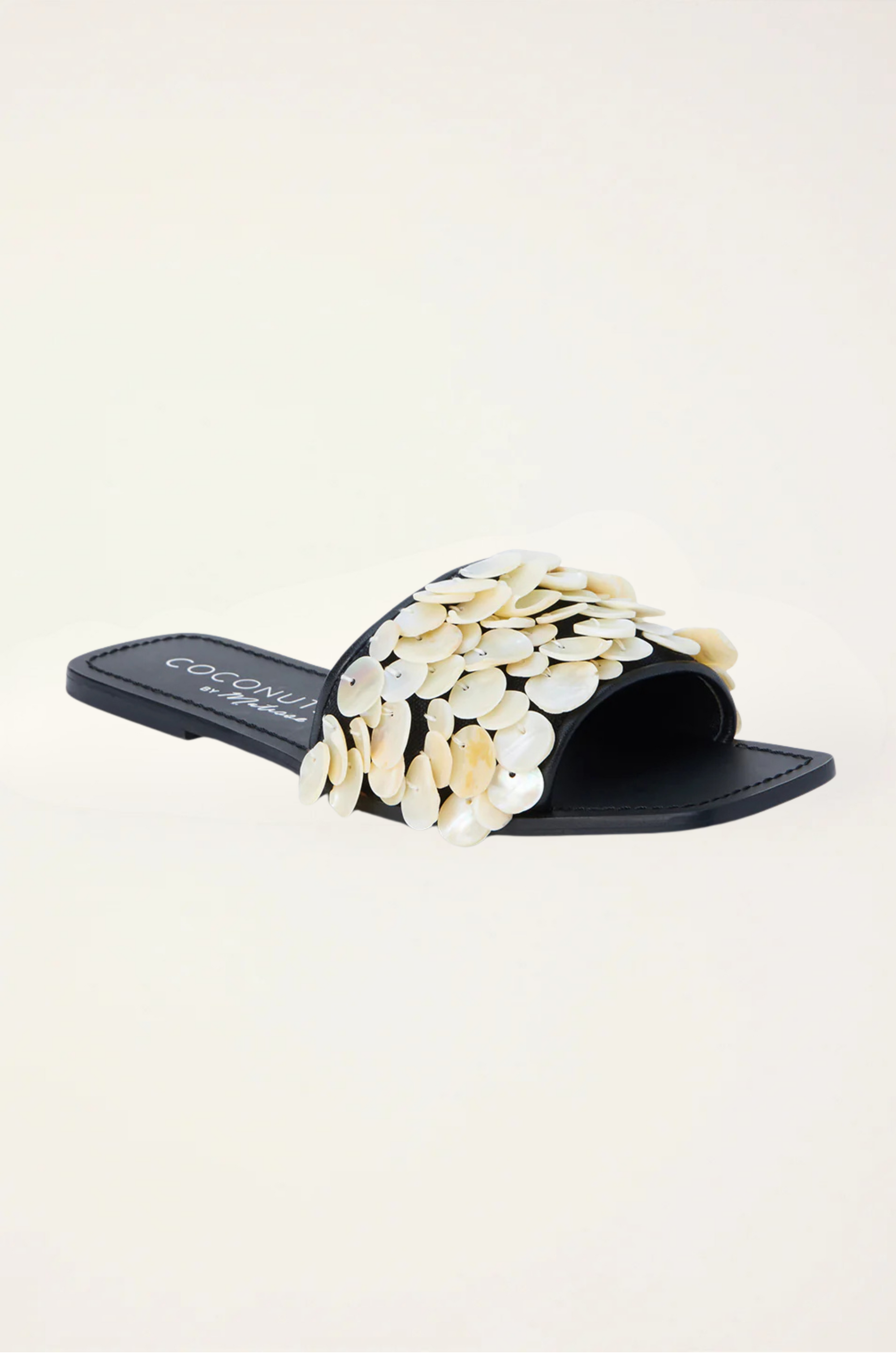 Natural shell-embellished slide sandals
Flat sole
Square toe
Delicate stitching detail