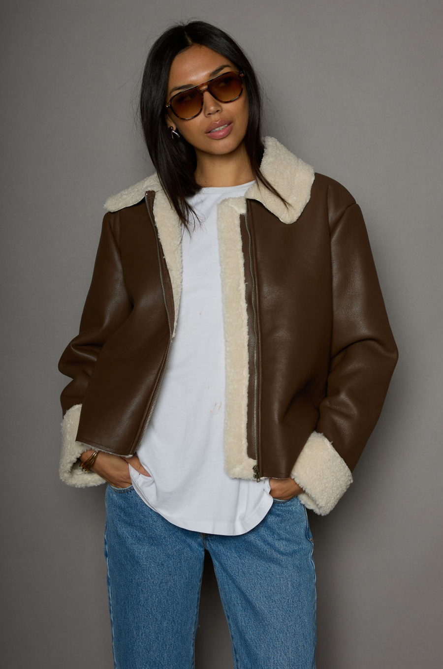 brown Faux leather jacket. Faux Sherpa trim and lining. Front zipper closure. Side pockets. winter jacket. winter coat. fall jacket. fall coat. 
