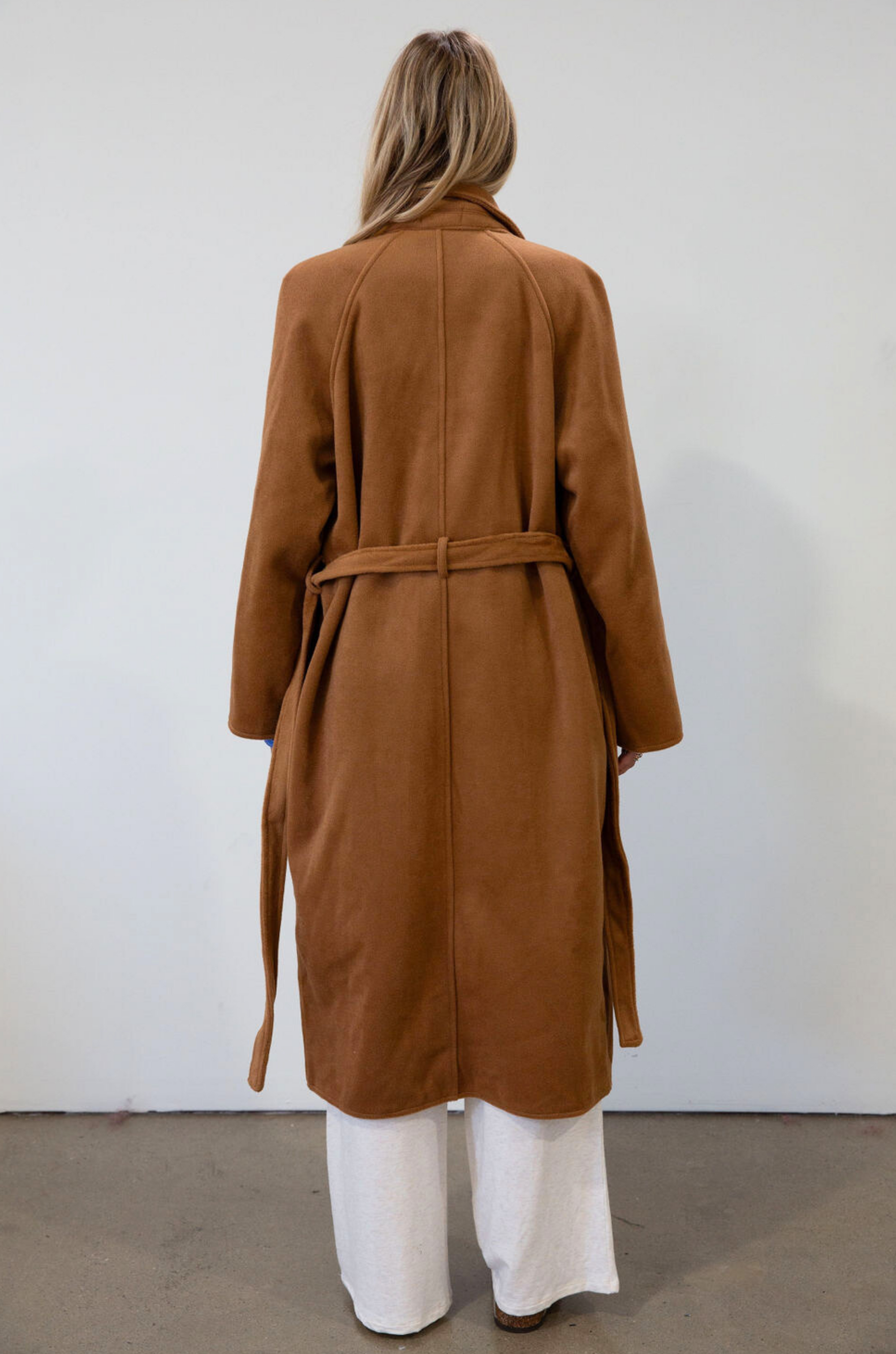 brown Vegan wool trench coat. Collar neckline. Long sleeves. Tie waist. Side pockets. Unlined. tan trench coat. fall outfit. fall jacket