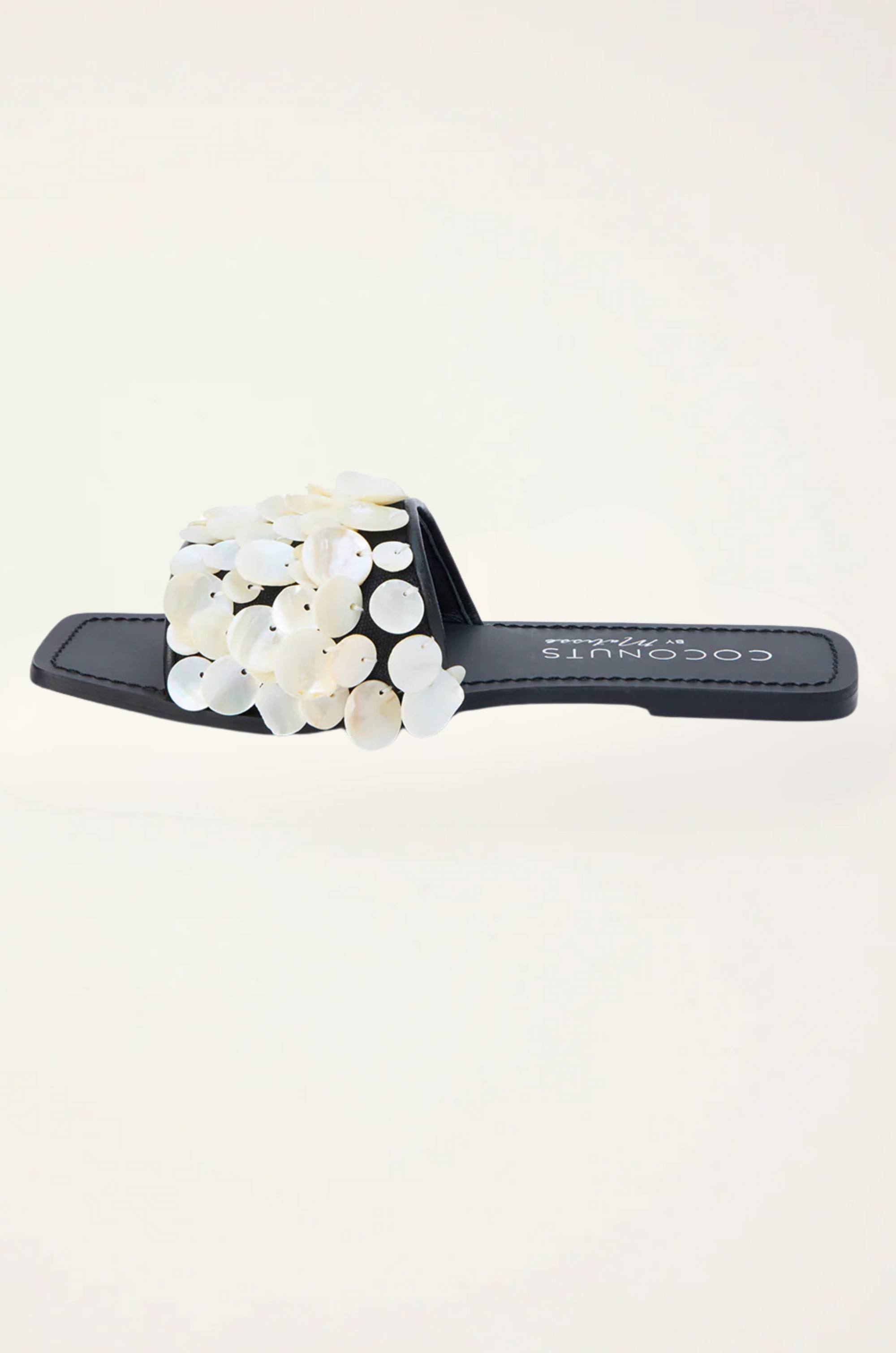 Natural shell-embellished slide sandals
Flat sole
Square toe
Delicate stitching detail