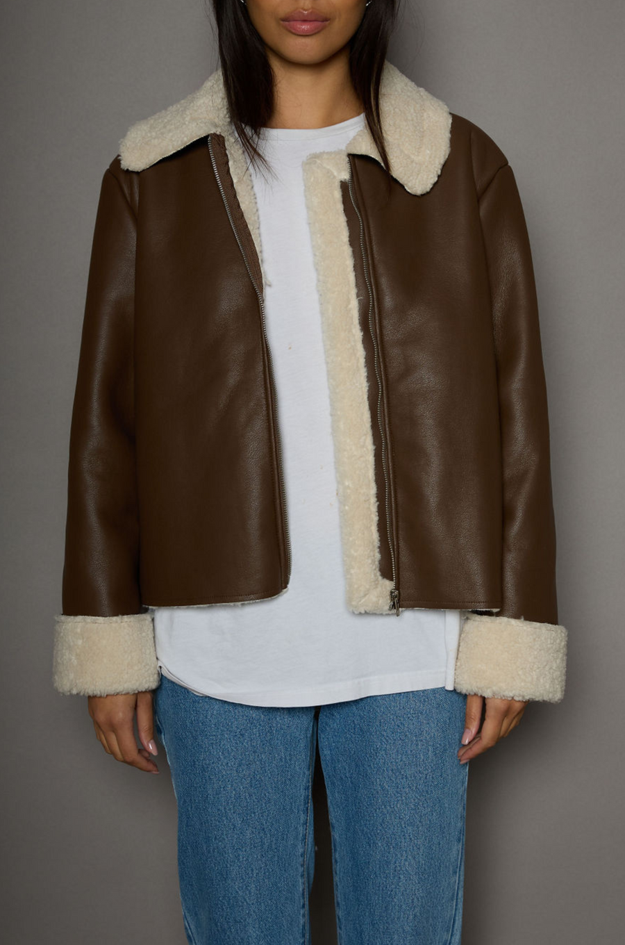 brown Faux leather jacket. Faux Sherpa trim and lining. Front zipper closure. Side pockets. winter jacket. winter coat. fall jacket. fall coat. 