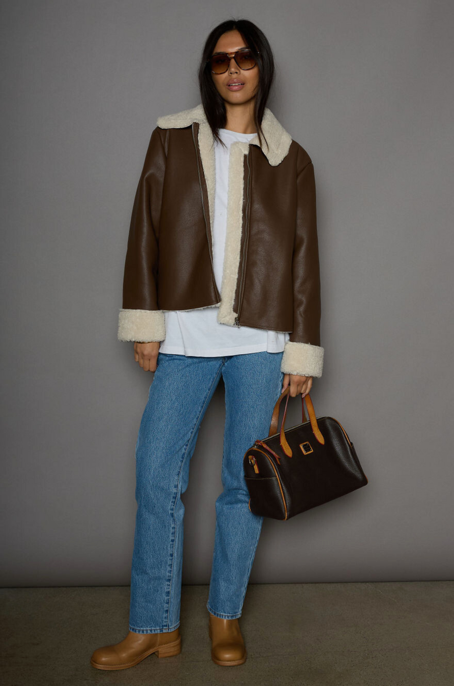 brown Faux leather jacket. Faux Sherpa trim and lining. Front zipper closure. Side pockets. winter jacket. winter coat. fall jacket. fall coat. 