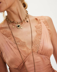 Ruched satin bodice tank top
Smocked backing
Lace trim throughout
V-neckline
Triangle cups
Full length
Asymmetrical hem
peach satin lace tank top