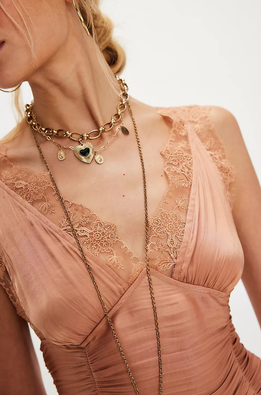 Ruched satin bodice tank top
Smocked backing
Lace trim throughout
V-neckline
Triangle cups
Full length
Asymmetrical hem
peach satin lace tank top