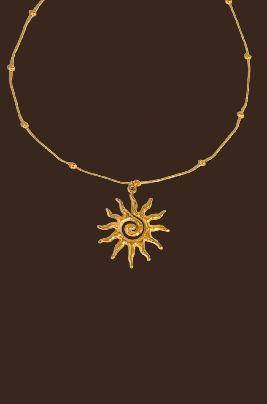 Gold necklace with a sun-shaped pendant necklace
18K Gold Non-Tarnish Boho Sun Necklace
18K Gold Plated
Stainless Steel
Pendant Size: 1.5" / Chain Length: 15.57" / Extension Length: 2"
Lead-free
Nickel-safe
Hypoallergenic
Water Resistant