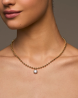 Delicate ball chain necklace anchored with a luminous CZ pendant
14kt gold plated brass&nbsp;or Rhodium plated brass
Stone is a white cz and measures 8.0mmNecklace measures 16" with a 3" extender
Lobster Clasp Closure
Gold chain necklace