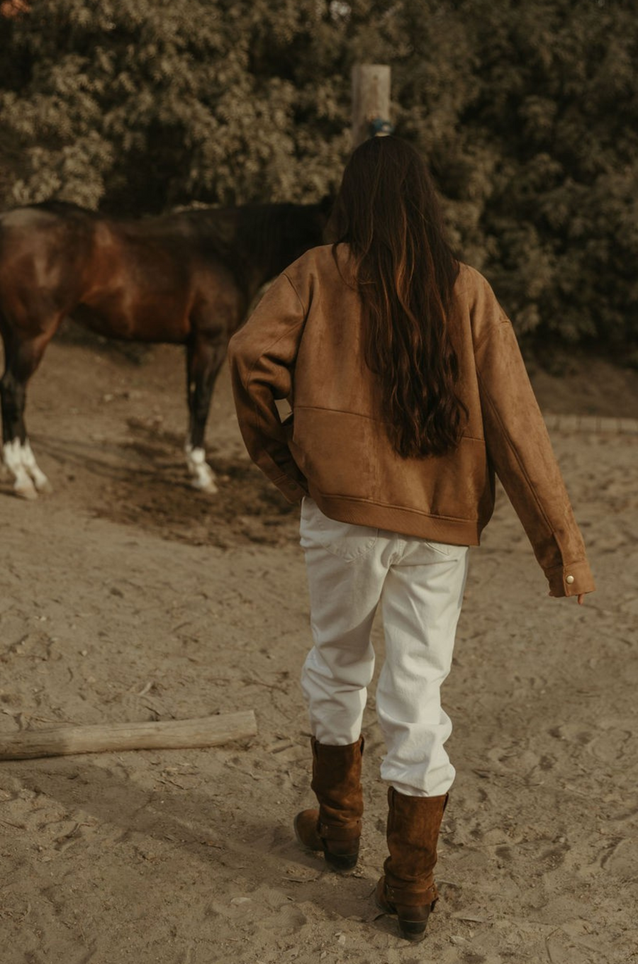Tan brown faux suede jacket. Front zipper closure. Front and side pockets. Long sleeves with button closures. Fully lined. suede bomber jacket