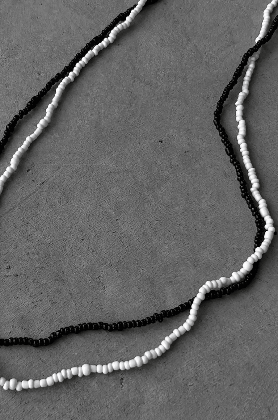 Two separate elastic beaded belly chains black and white belly chain