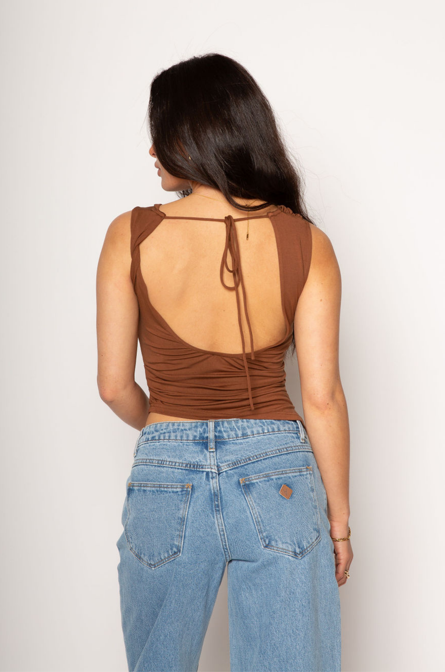 Knit ruched asymmetric top. Sleeveless. Open back with tie closure. Elastic back. Partially lined. going out top. brown cowl neck tank top. 