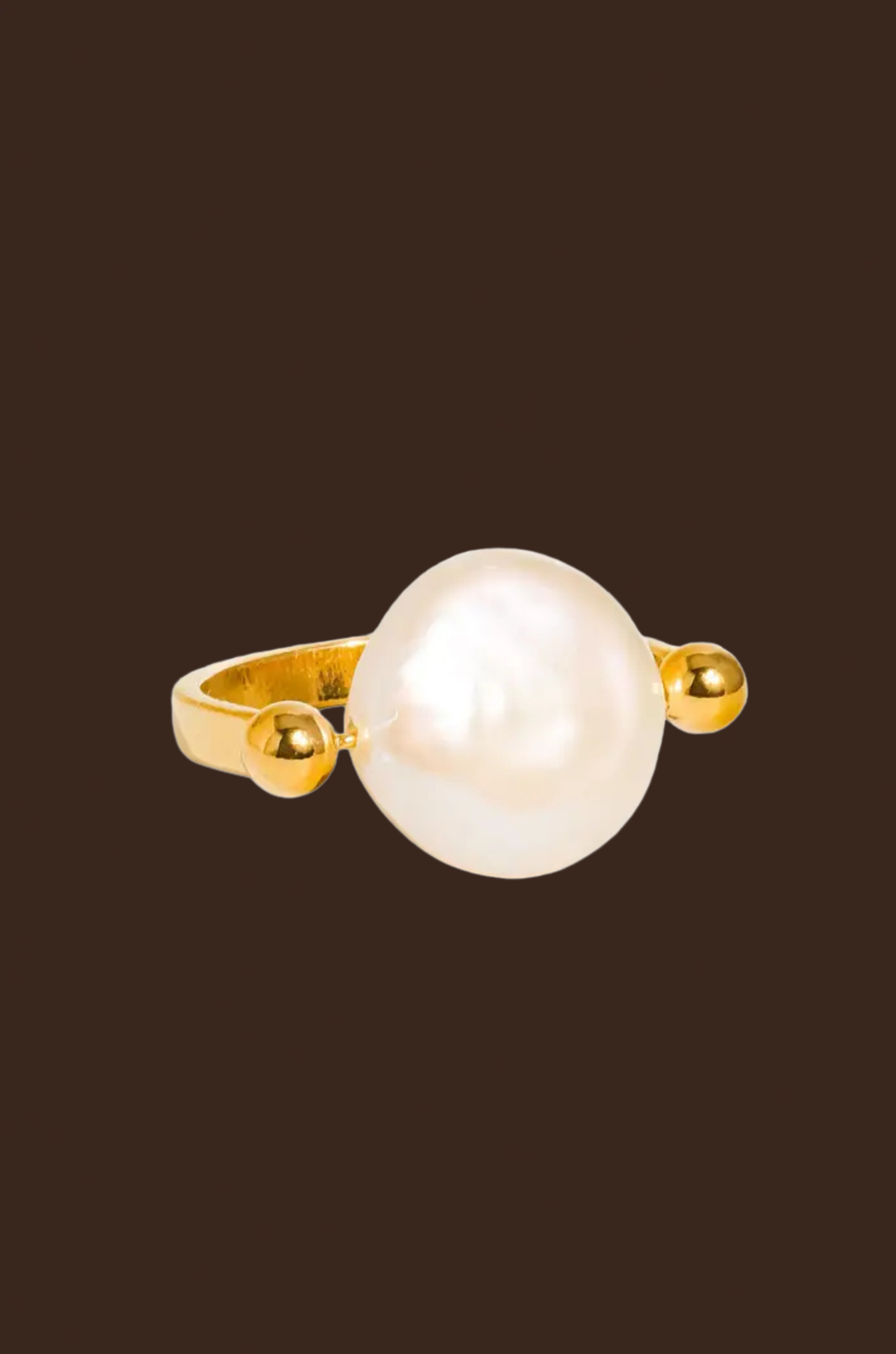Gold ring with a large pearl
18K Gold Non-Tarnish Baroque Pearl Ring
18K Gold Plating
Stainless Steel
Faux Pearl
Size 7 Measurement: 0.682 Diameter/2.14 Circumference
Lead-free
Nickel-safe
Hypoallergenic
Water Resistant