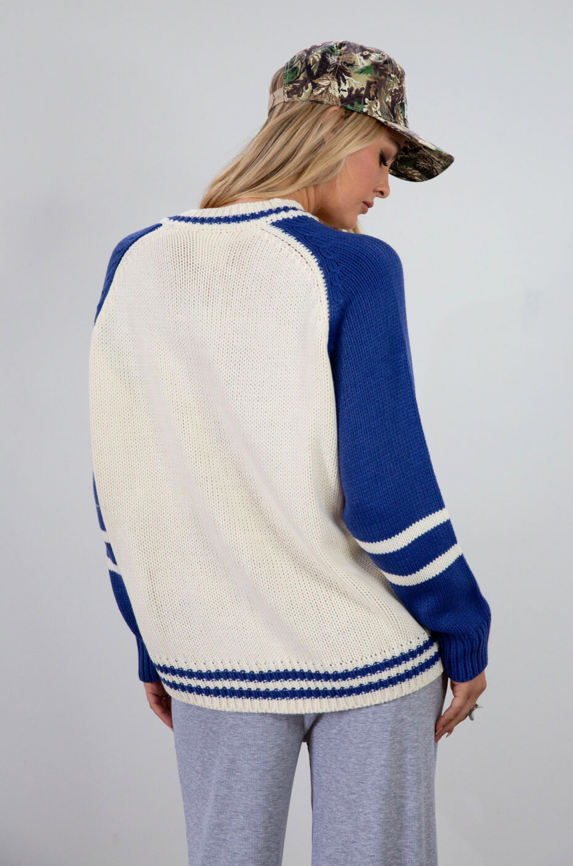 Colorblocked crochet knit cardigan. Crewneck. Long sleeves. Front button down closures. Front pockets. Unlined. ivory and blue sweater cardigan. fall top. fall sweater. oversized sweater