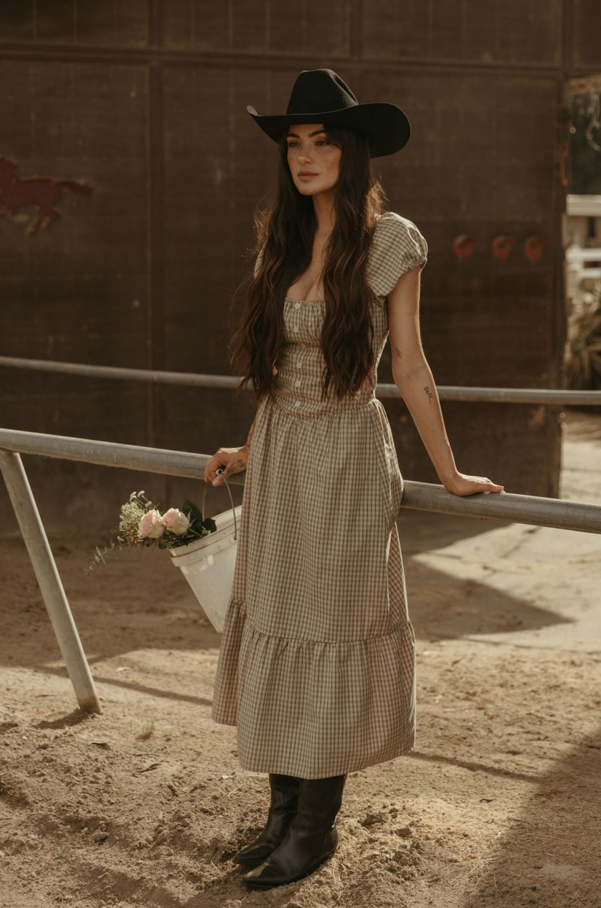 Checkered printed woven maxi dress. Elastic neckline. Short sleeves with elastic openings. Faux front button closures. Back hook and eye and zipper closures. Partially lined. plaid maxi dress. western outfit. ranch outfit. country dress