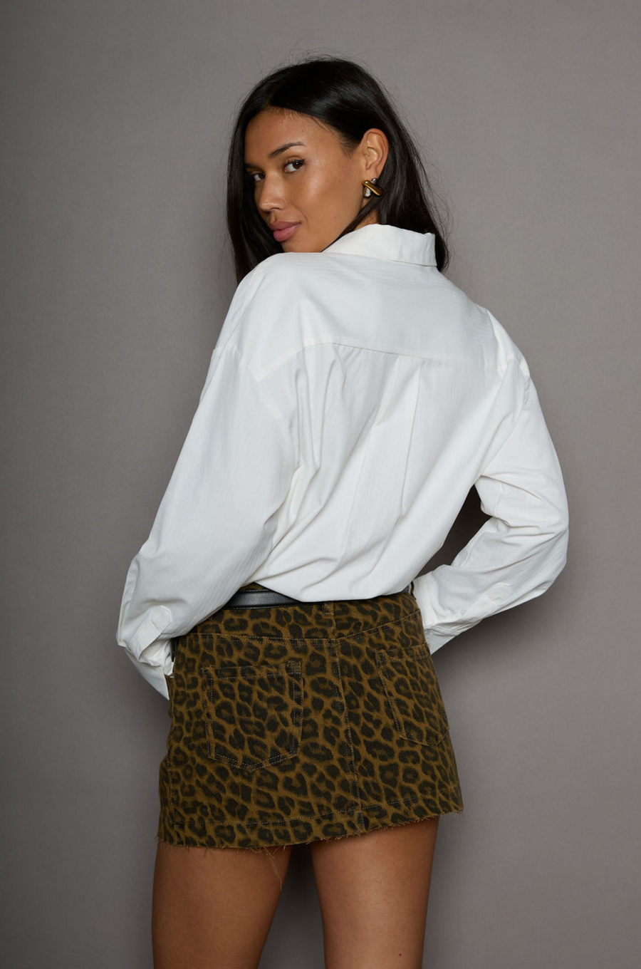 Animal printed denim skirt. Button and zipper fly. Five pocket construction. Frayed hem. Unlined. leopard mini skirt. going out mini skirt. 
