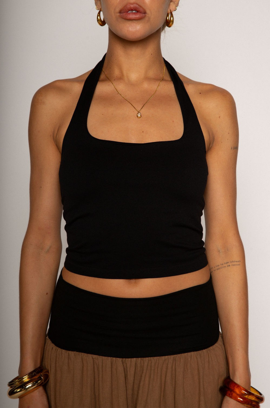 Knit crop top. Elastic halter neckline. Partially lined. going out top. black halter crop top