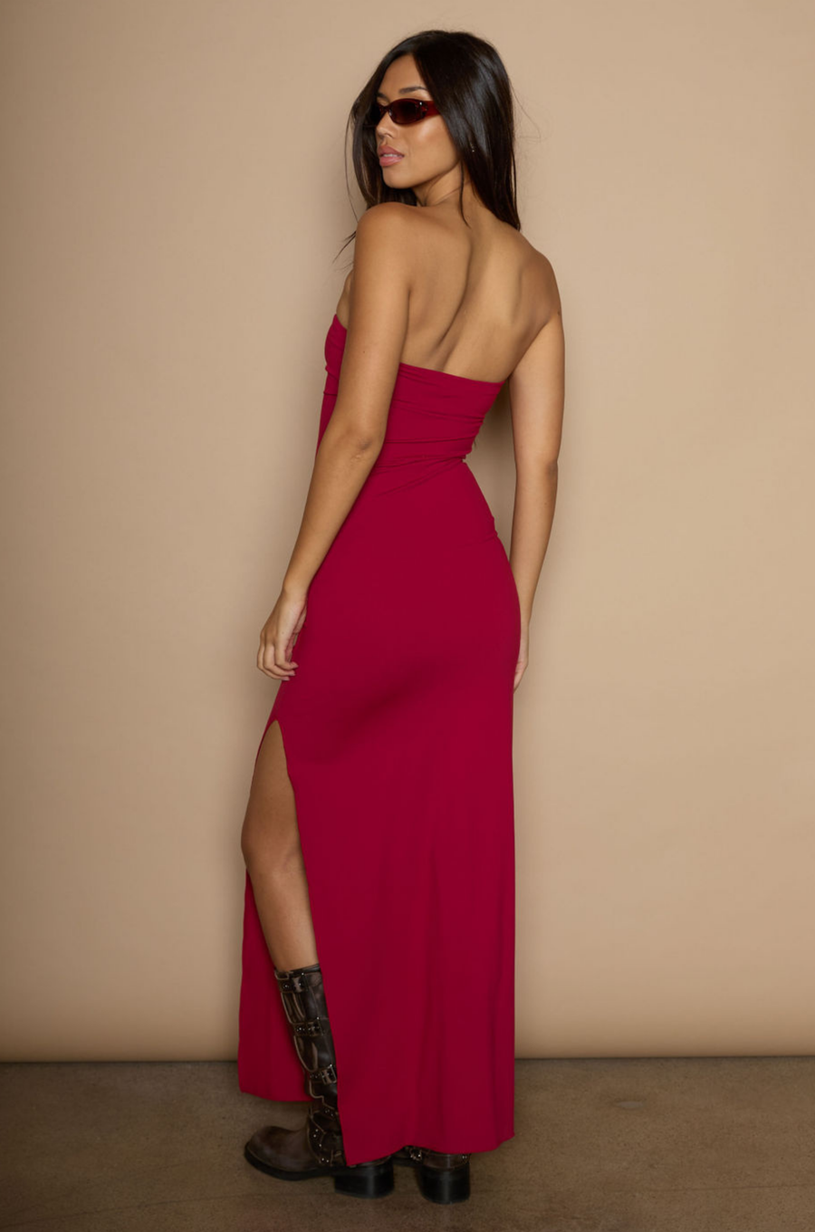 Knit maxi dress. Strapless neckline. Ruched front. Side slit. Partially lined. red strapless maxi dress. holiday maxi dress. holiday look. 