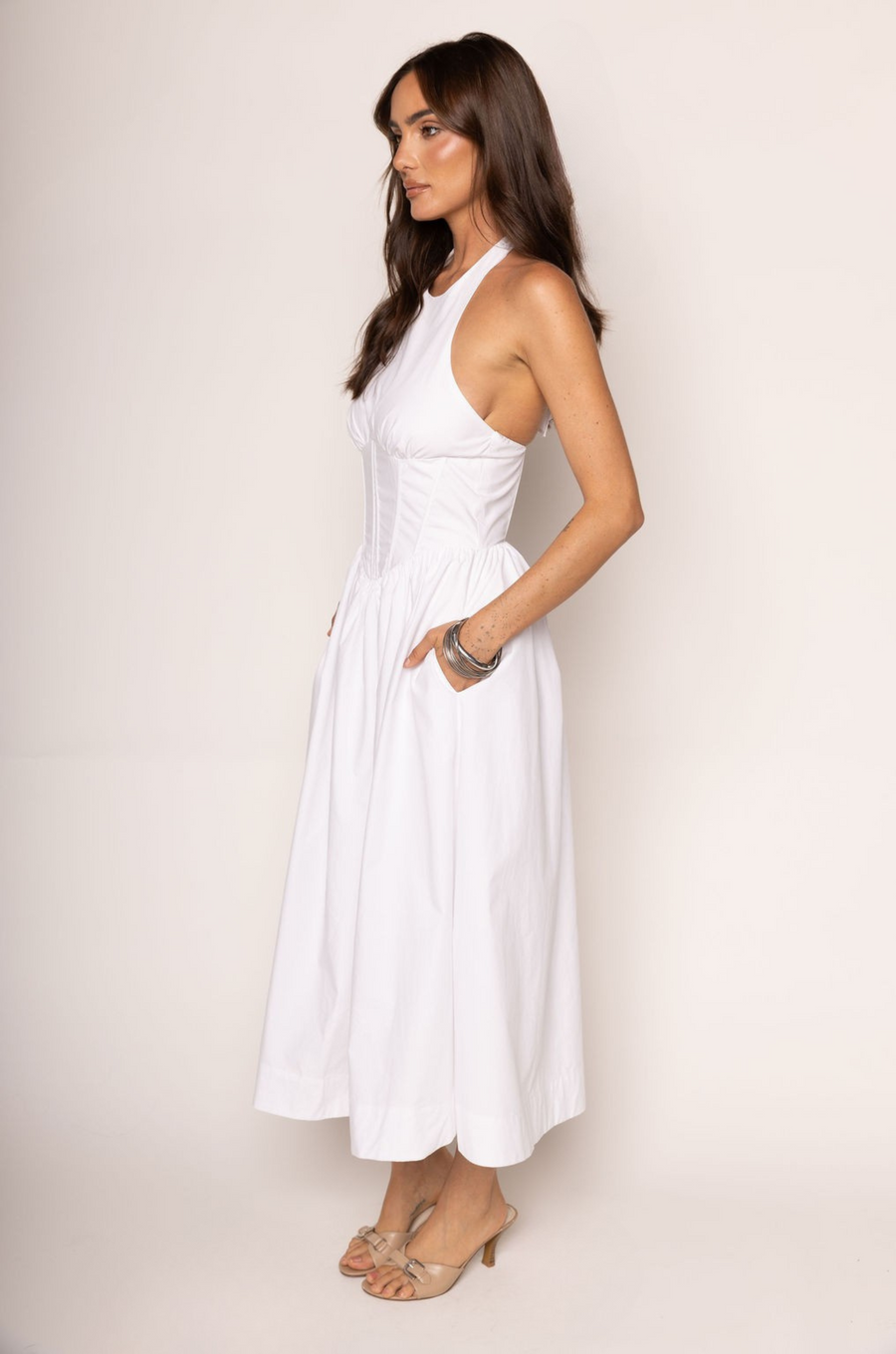 Woven midi dress
Adjustable halter neckline
Boning in bodice
Side pockets
Elastic back neckline
Back hook and eye and zipper closures
Fully lined
white midi dress
bridal dress
bridal shower dress