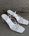 Osara by Billini is a white strappy mid block heel.

A must have for all occasions, this strappy barely-there block heel ticks all the boxes.

Featuring

shaved mid block heel
open square toe
thin, tubular strappy upper
elasticated sling back strap
exposed heel counter
synthetic upper, lining and outsole
Heel height 9cm.