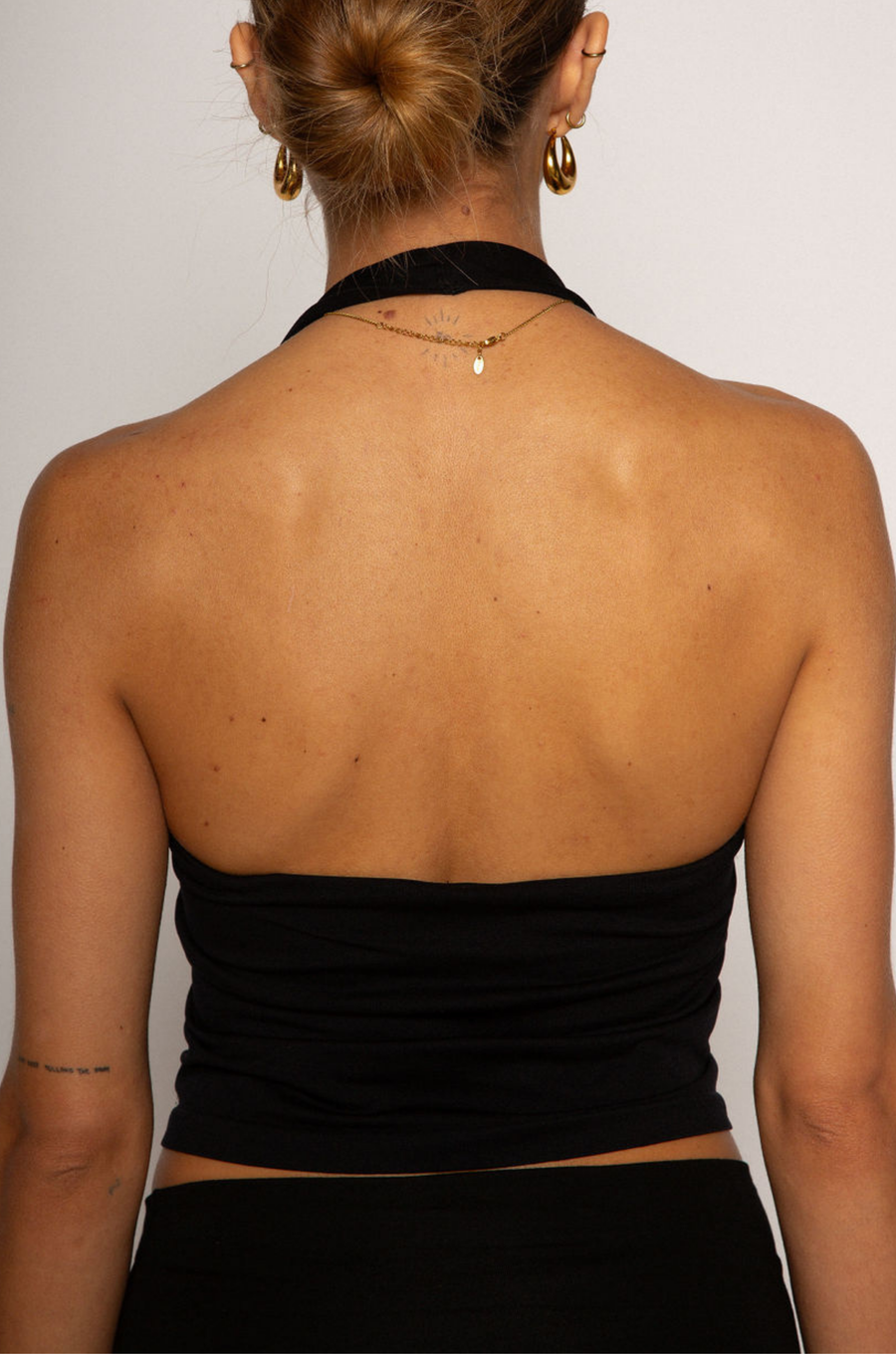 Knit crop top. Elastic halter neckline. Partially lined. going out top. black halter crop top