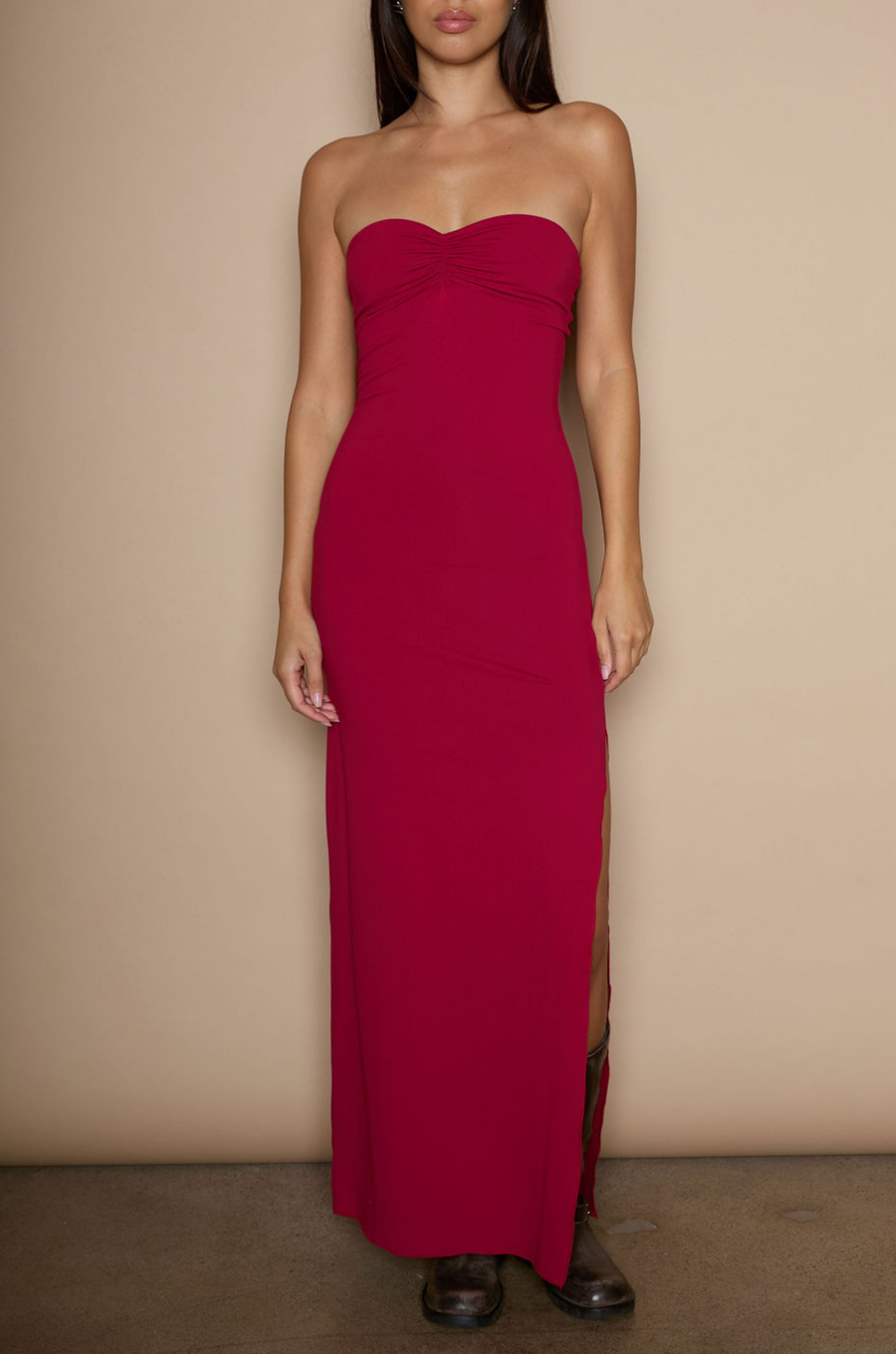 Knit maxi dress. Strapless neckline. Ruched front. Side slit. Partially lined. red strapless maxi dress. holiday maxi dress. holiday look. 