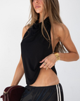 black Halter neck top
Low back
Neck button closure
Partially lined
