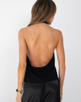 black Halter neck top
Low back
Neck button closure
Partially lined
