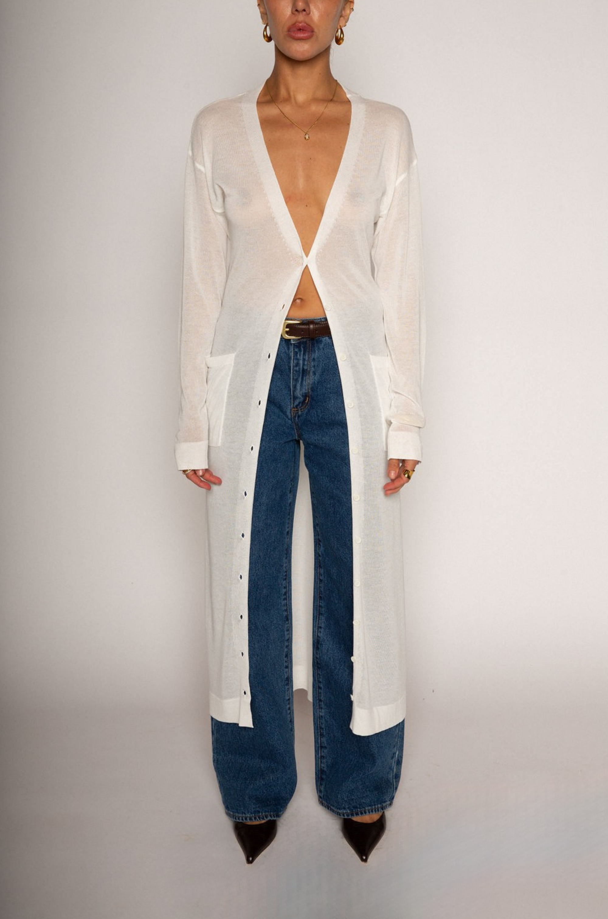 white Thin knit longline cardigan
Long sleeves
Front button down closure
Front pockets
Side slits
Unlined
pool cover up
beach cover up