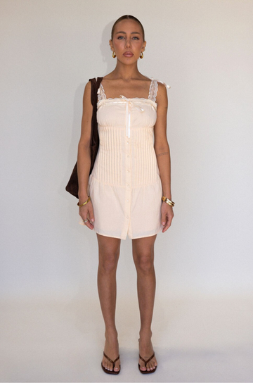 tan Woven coquette mini dress
Front bow detail
Front button closure
Adjustable lace and ribbon shoulder straps
Pintuck details on bodice
Smocked backing
Lined
summer mini dress
spring mini dress