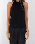 black Halter neck top
Low back
Neck button closure
Partially lined
