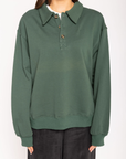 Knit sweater top
Collar neckline
Front button down closure
Unlined
hunter green sweater
