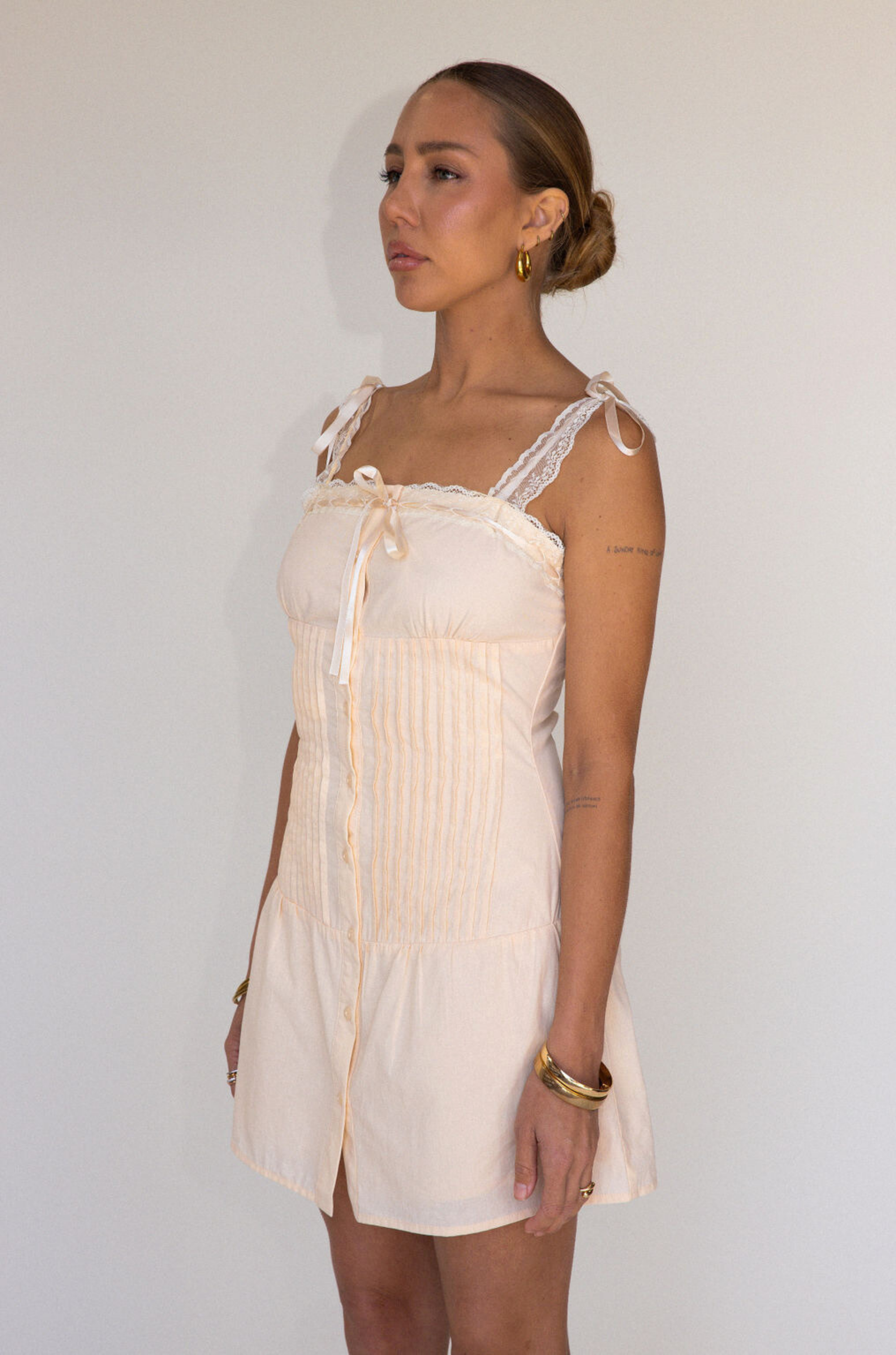 tan Woven coquette mini dress
Front bow detail
Front button closure
Adjustable lace and ribbon shoulder straps
Pintuck details on bodice
Smocked backing
Lined
summer mini dress
spring mini dress