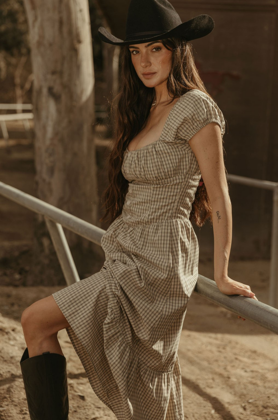 Checkered printed woven maxi dress. Elastic neckline. Short sleeves with elastic openings. Faux front button closures. Back hook and eye and zipper closures. Partially lined. plaid maxi dress. western outfit. ranch outfit. country dress