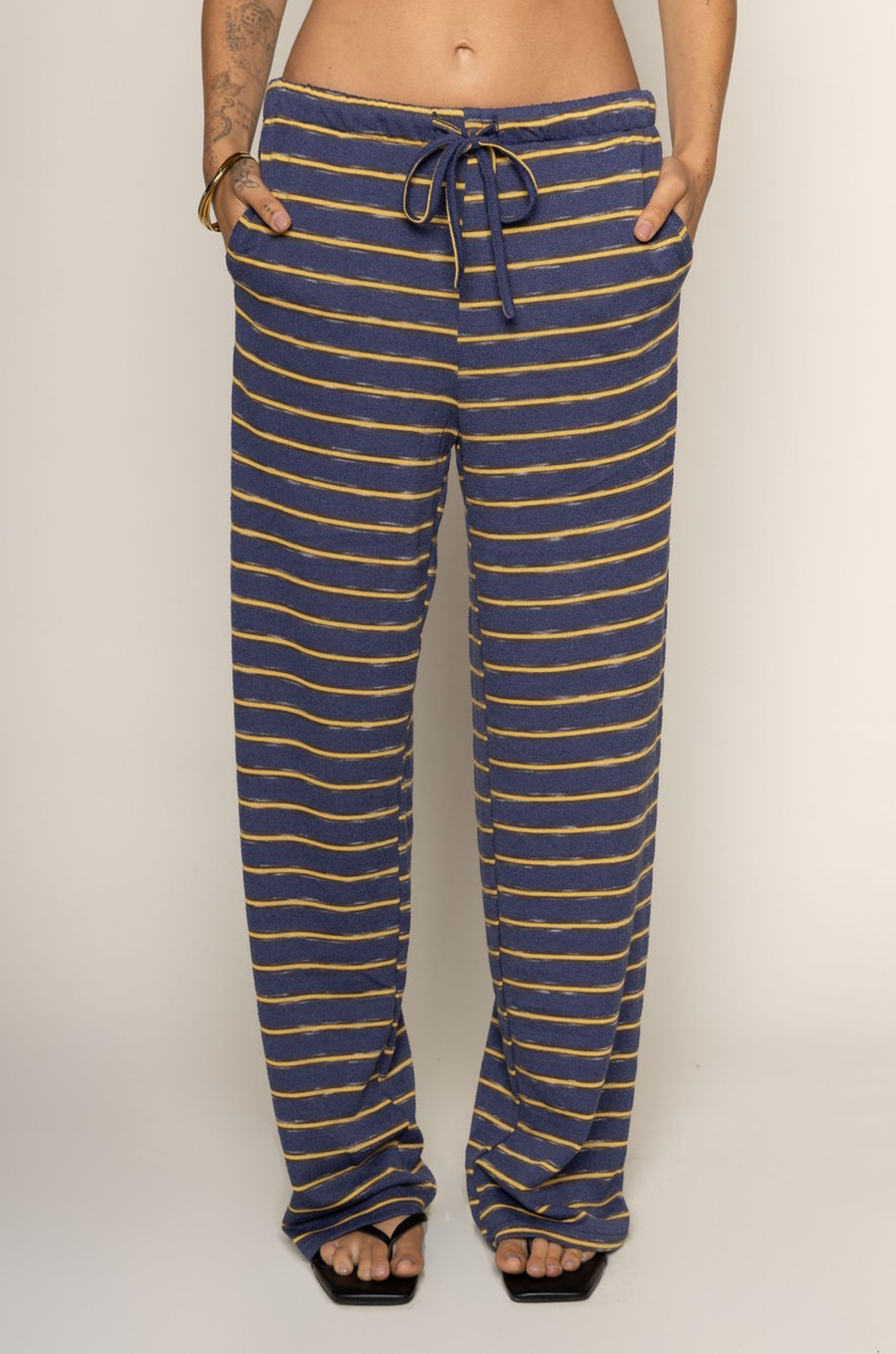 TOP:
blue and yellow Striped knit tube top
Side slits
Rubber grip lining
Unlined

BOTTOM:
blue and yellow Striped knit pants
Elastic waistband
Adjustable waistband tie
Unlined
cute loungewear
beach day outfit
fourth of july cute casual outfit
striped lounge pant set