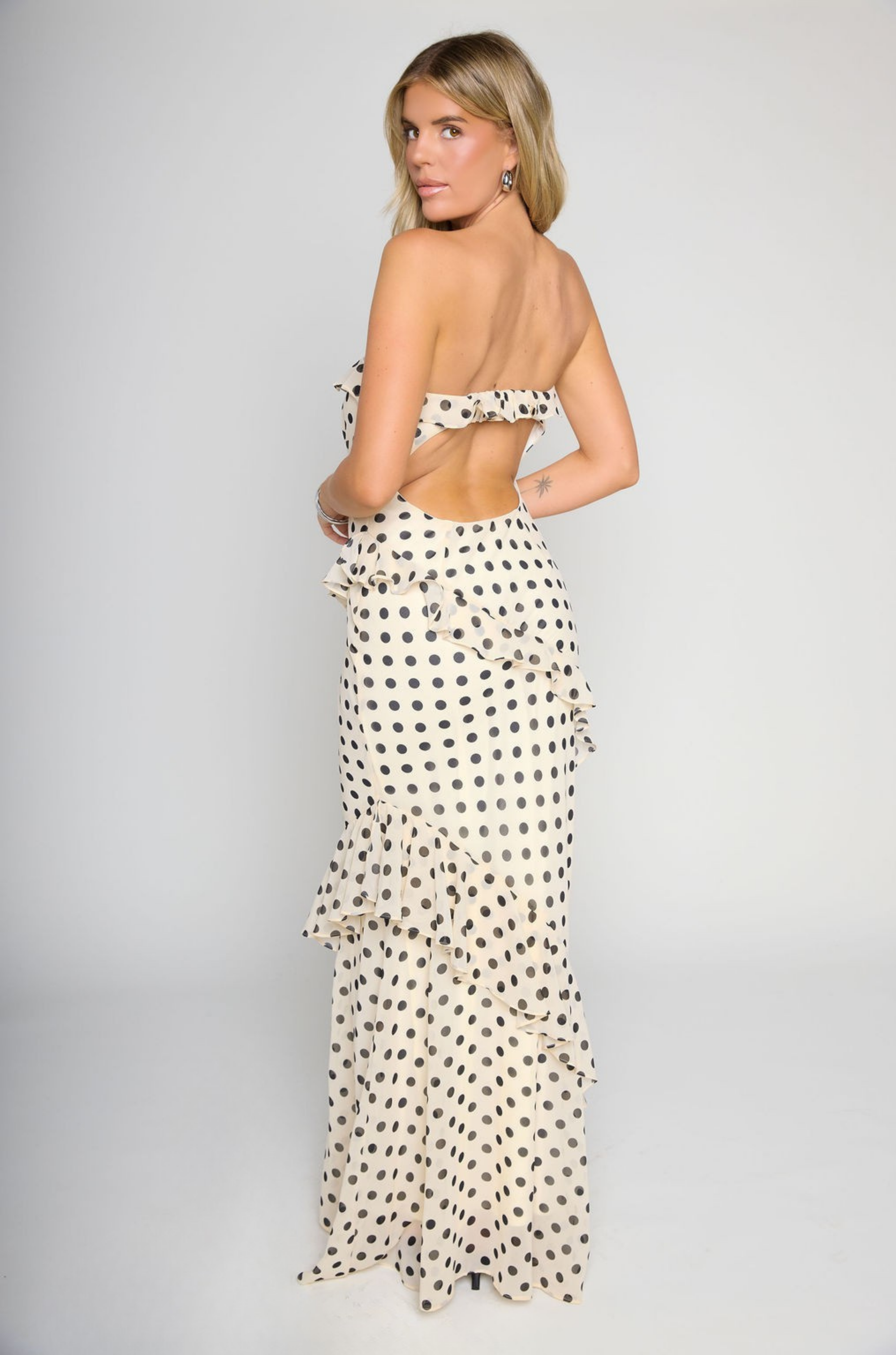 Polka dot printed maxi dress
Tube top
Ruffle on bust trim
Asymmetric ruffle detail on bottom half
Back cut out
Inner rubber grip lining
Side zipper closure
Lined
cream and black polka dot dress
bridal maxi dress