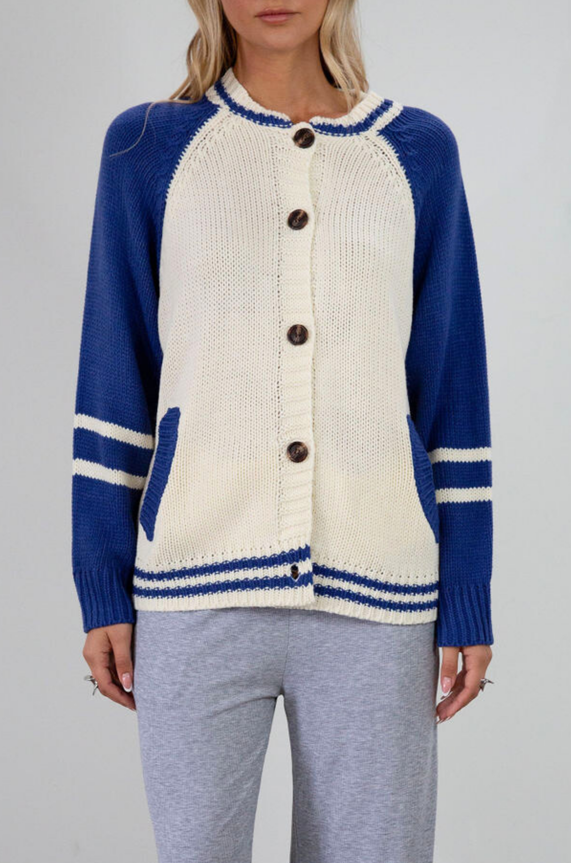 Colorblocked crochet knit cardigan. Crewneck. Long sleeves. Front button down closures. Front pockets. Unlined. ivory and blue sweater cardigan. fall top. fall sweater. oversized sweater