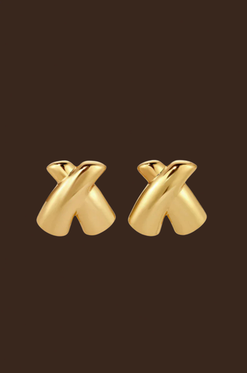 Gold 'X' shaped earrings on a dark brown background