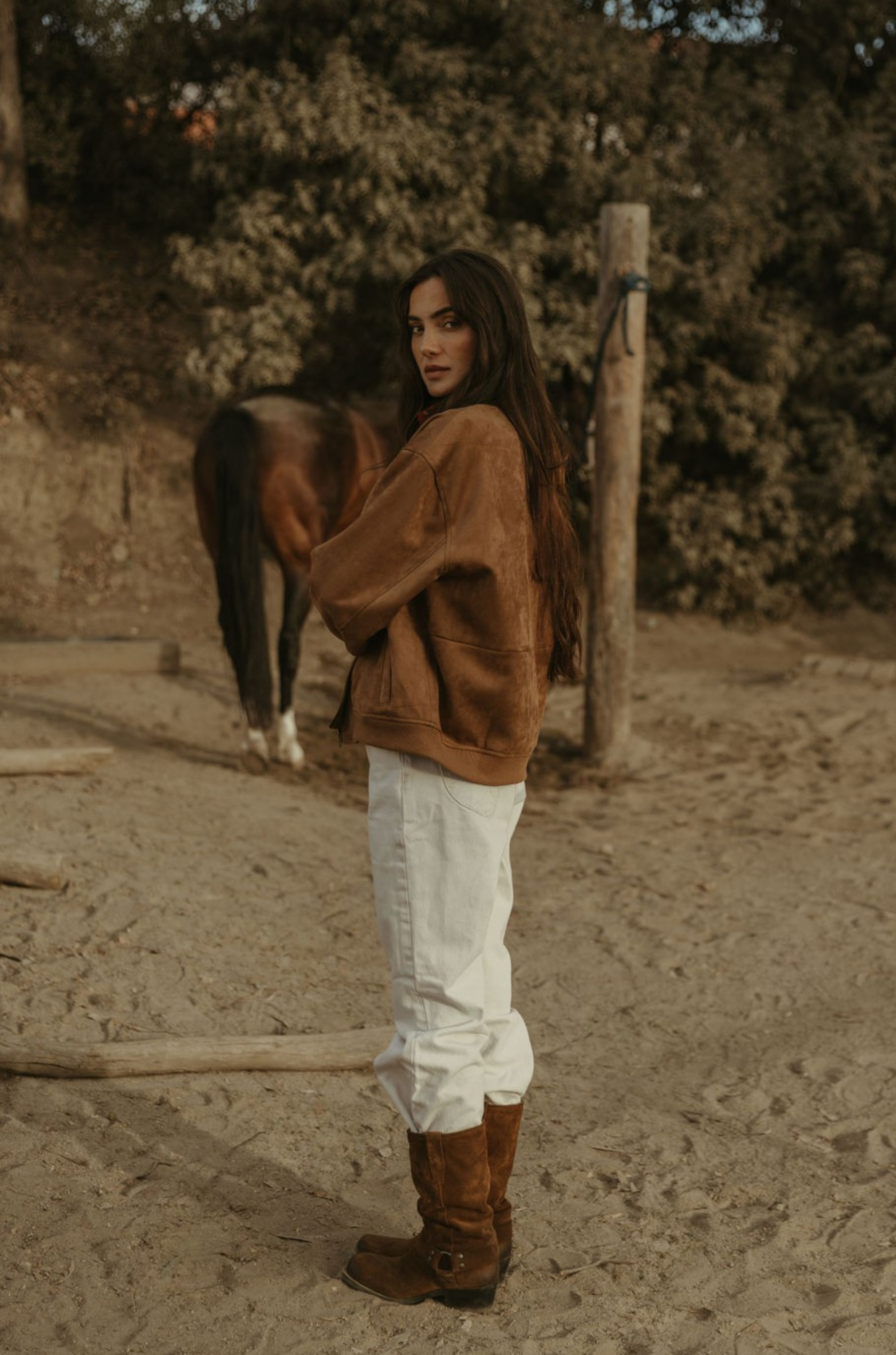 Tan brown faux suede jacket. Front zipper closure. Front and side pockets. Long sleeves with button closures. Fully lined. suede bomber jacket
