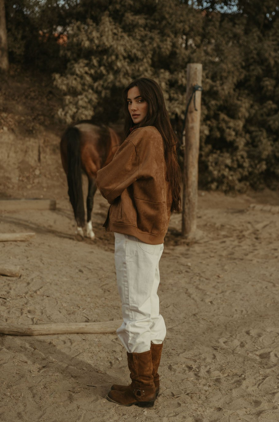 Tan brown faux suede jacket. Front zipper closure. Front and side pockets. Long sleeves with button closures. Fully lined. suede bomber jacket