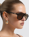 Modern aviator-inspired frame
Featuring a bold flat-top silhouette with geometric shaping
Navigator-inspired angular shaping
Oversized lens profile for full coverage
Polarisation: Category 3
UV Protection: UV400
Double bridge design
Keyhole cut-out detail between bridges
Slim arm design
Lens Height: 5.16cm / Temple Length: 14.5cm / Temple Tip Width: 10.5cm /
Nose Bridge: 1.8cm, Frame Width: 14.4cm