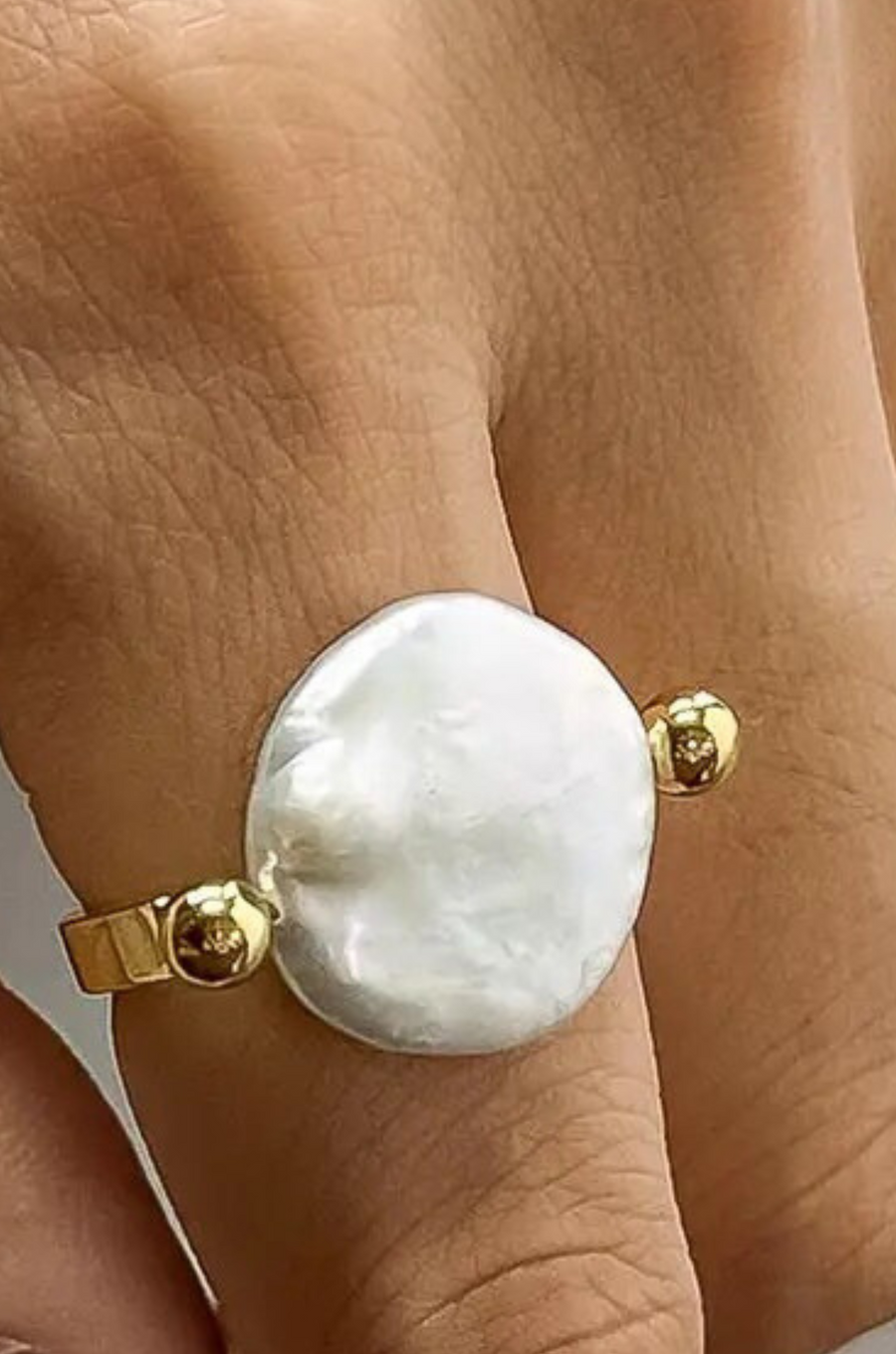 Gold ring with a large pearl
18K Gold Non-Tarnish Baroque Pearl Ring
18K Gold Plating
Stainless Steel
Faux Pearl
Size 7 Measurement: 0.682 Diameter/2.14 Circumference
Lead-free
Nickel-safe
Hypoallergenic
Water Resistant
