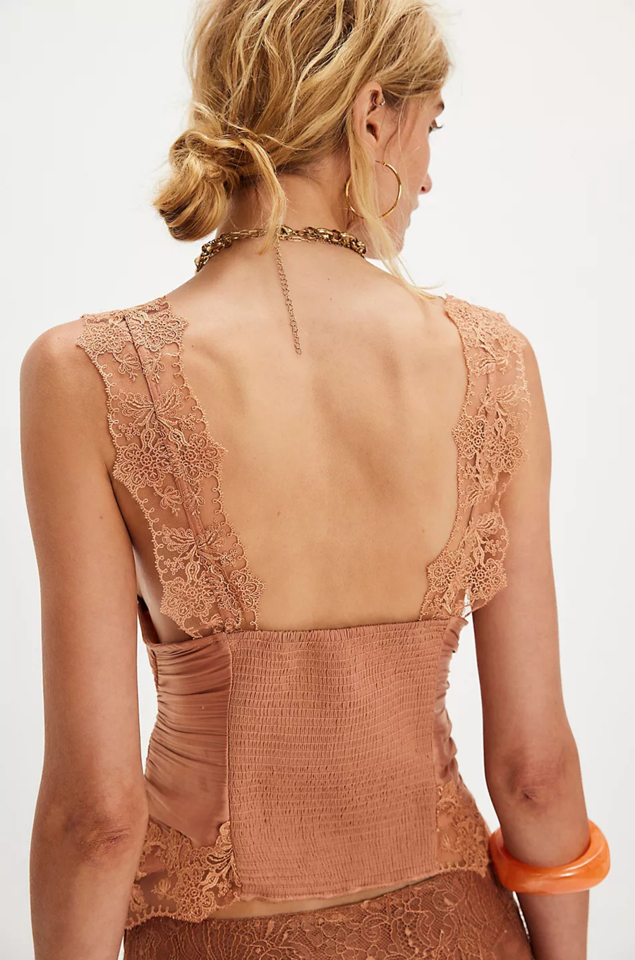 Ruched satin bodice tank top
Smocked backing
Lace trim throughout
V-neckline
Triangle cups
Full length
Asymmetrical hem
peach satin lace tank top