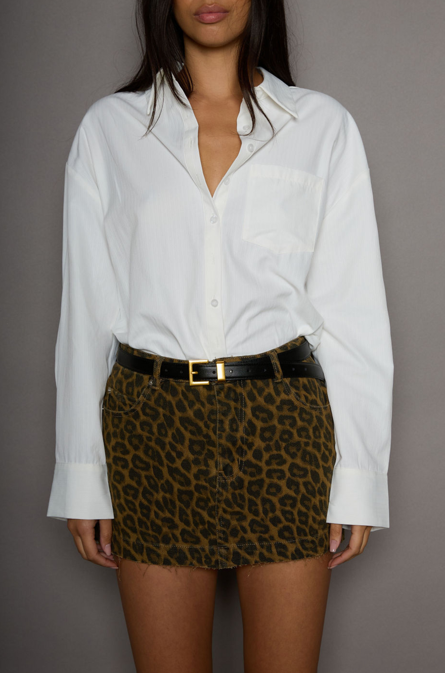 Animal printed denim skirt. Button and zipper fly. Five pocket construction. Frayed hem. Unlined. leopard mini skirt. going out mini skirt. 