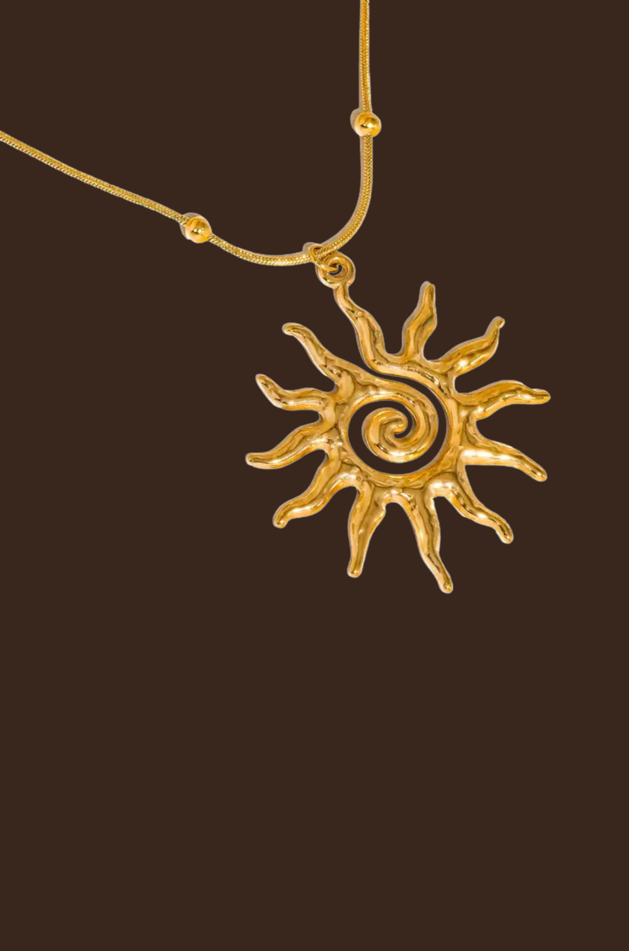 Gold necklace with a sun-shaped pendant necklace
18K Gold Non-Tarnish Boho Sun Necklace
18K Gold Plated
Stainless Steel
Pendant Size: 1.5" / Chain Length: 15.57" / Extension Length: 2"
Lead-free
Nickel-safe
Hypoallergenic
Water Resistant