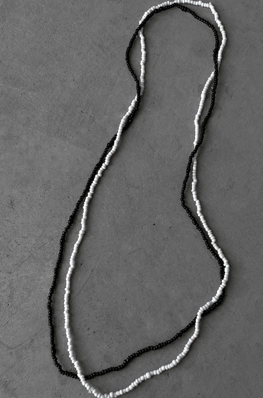 Two separate elastic beaded belly chains black and white belly chain