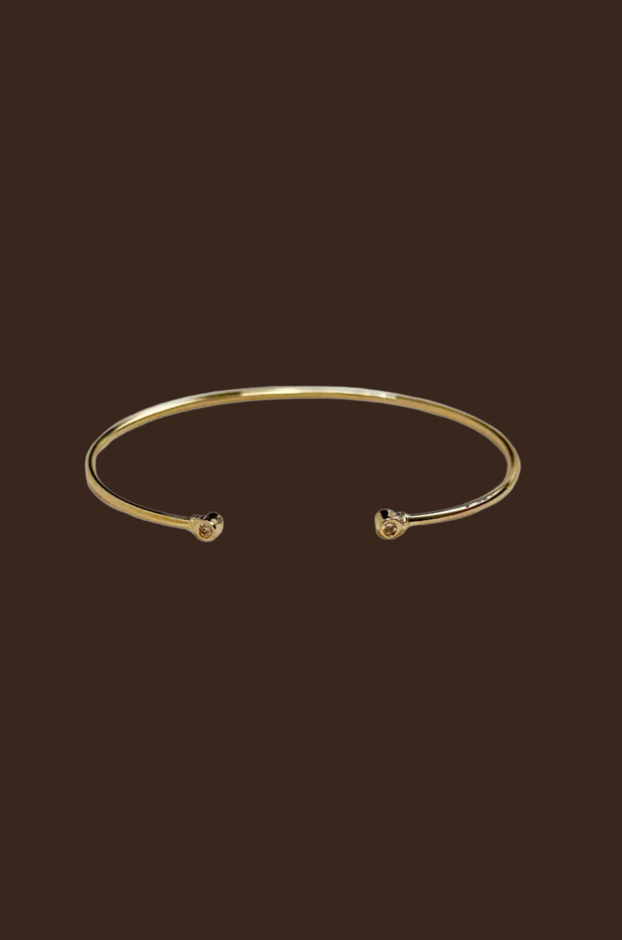 Gold cuff bracelet 
18k Gold Filled Open CZ Cuff Bracelet
60mm diameter - adjustable sizing
Hypoallergenic jewelry
Nickel Free
Water-resistant